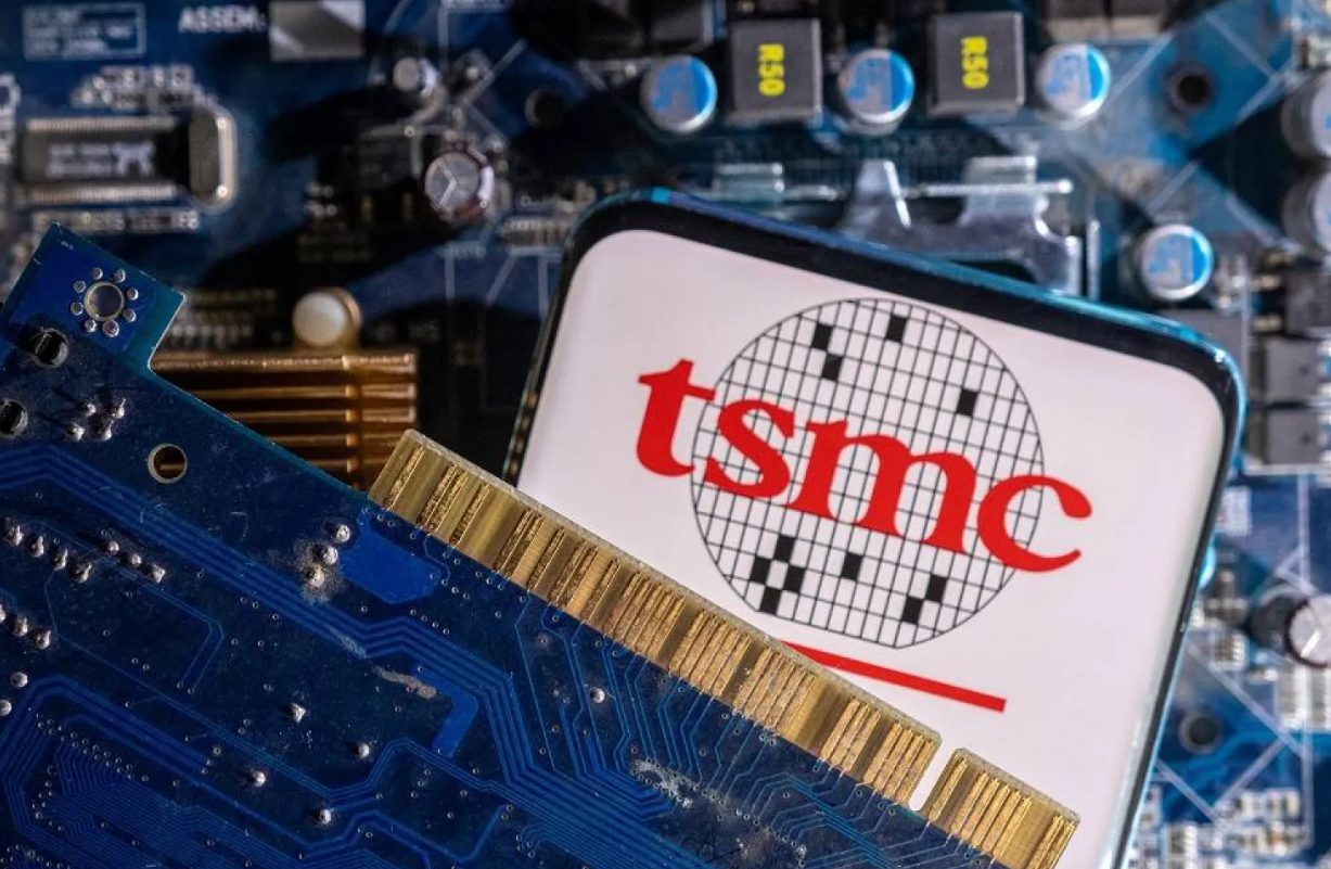A smartphone with a displayed TSMC (Taiwan Semiconductor Manufacturing Company) logo is placed on a computer motherboard. Source: Reuters.